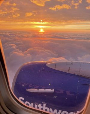 finding the right doctor | Scleroderma News | A snapshot taken from a window seat of a Southwest Airlines flight shows a bright orange sunrise over white, fluffy clouds